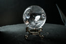 Water-Clear Quartz Sphere with Vivid Rainbows & Leaf-Shaped Feather Inclusions – Diamantina, Brazil (71 mm | 460 g) - E2D Crystals & Minerals
